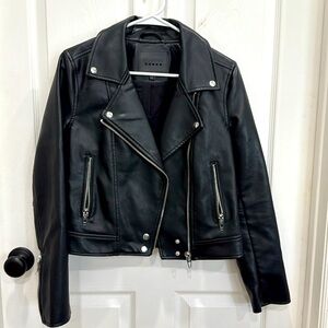 Faux black leather jacket with zippers and snaps. Women’s size small.